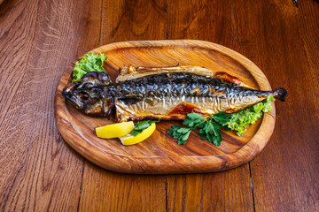 Fish dish with different ingredients on a wooden table in the pub