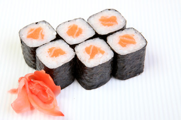 Rolls of Syak maki. Japanese food on a beautiful dish. Dietary food. An exquisite Japanese dish. Fresh dish of fish.