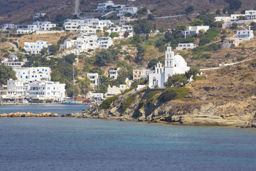 Chora - The church Agia Irini on the right side and Chora town on the Ios island in the Aegean Sea...