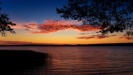 Fototapeta na wymiar The background of the sunset over the lake