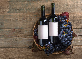 Grapes and bottles of red wine.