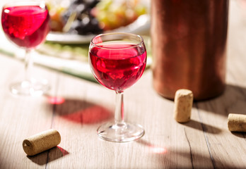 Glasses of rosé wine near a bucket on the table
