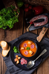 Hungarian paprika cream soup with spicy sausage