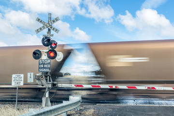 Railway crossing and coal train showing movement