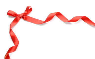 Red ribbon with bow on white background