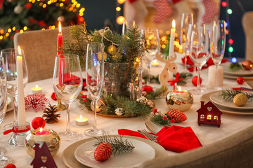 Stylish table setting with burning candles and Christmas decorations