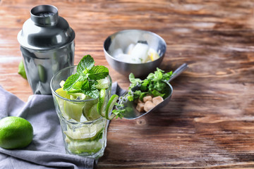 Glass of fresh mojito on wooden table