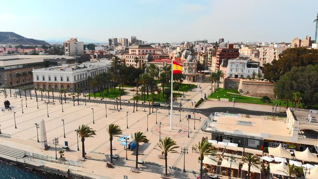 Fluttering national Spanish flag in the main square of the Cartagena. Aerial view. Europe  Spain,  Region of Murcia,  Municipality of Cartagena,  Cartagena.