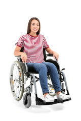 Obraz na płótnie Canvas Young woman sitting in wheelchair on white background