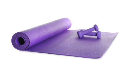 Color yoga mat with dumbbells on white background