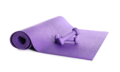Color yoga mat with dumbbells on white background