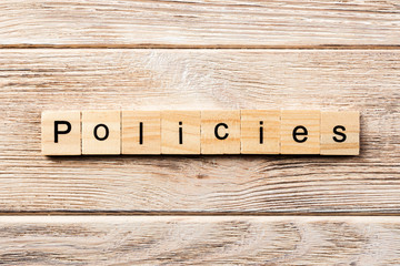 policies word written on wood block. policies text on table, concept