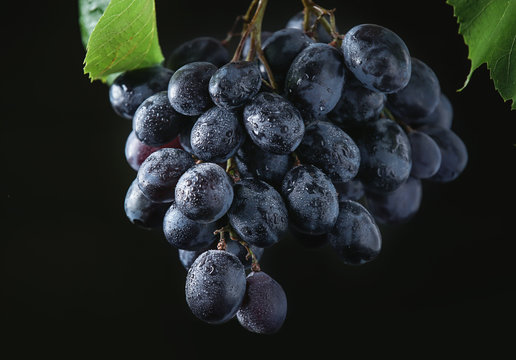 Ripe sweet grapes on dark background