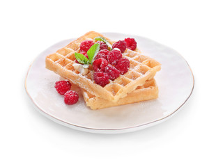 Plate with delicious waffles and raspberries on white background