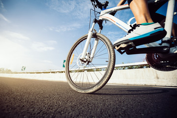Fototapeta na wymiar Cyclist legs riding Mountain Bike on highway