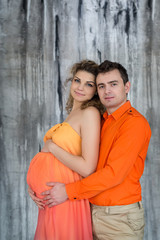 Pregnant couple on the loft background