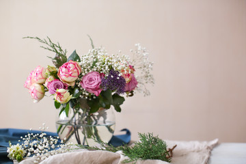 Vase with beautiful flowers on table