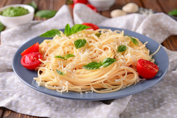Delicious pasta with basil, cheese and tomatoes on plate