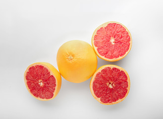 Ripe juicy grapefruits on white background