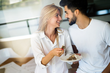 Cute young cheerful couple spending time at home