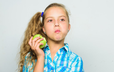 Good nutrition is essential to good health. Kid girl eat green apple fruit. Vitamin nutrition concept. Reasons eat apple every day. Nutritional content of apple. Apple a day keeps doctor away
