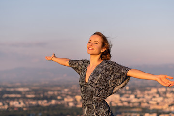 Christian worship and praise. A young woman with her hands raised in worship and praise to god.