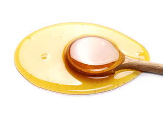 Honey with wooden spoon isolated on white background