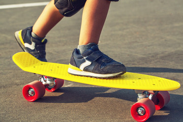 The child's legs on plastboard close up.