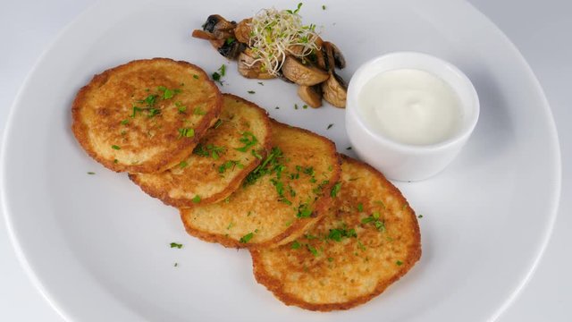 Potato pancakes, fried, served with sour cream and mushrooms, served in Restaurant, loop