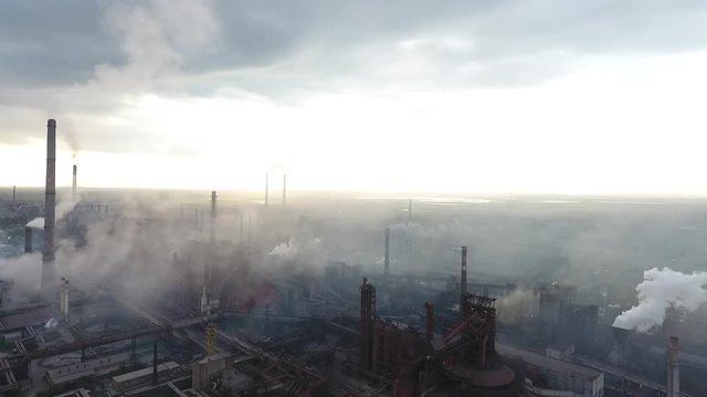 Bad ecology. Smoke and fog from pipes on the steel plant, factory.