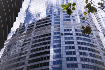 Fototapeta na wymiar View of window cleaner on wall of skyscraper