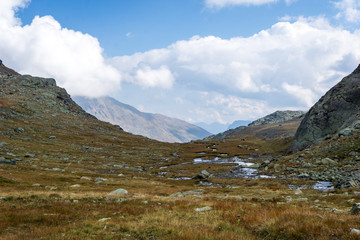 Idyllic view of Adamello Brenta National Park with rocks and a river , marshland, South Tyrol, Italy