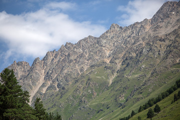Fototapeta premium Photo of mountain slopes with vegetation and cloudy sky