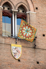  Palio flags and badges. The Palio of St. George is a typical medieval festival. Detail of Palio shield decoration. Palazzo Municipale (Town Hall) in  Ferrara Emilia-Romagna Italy