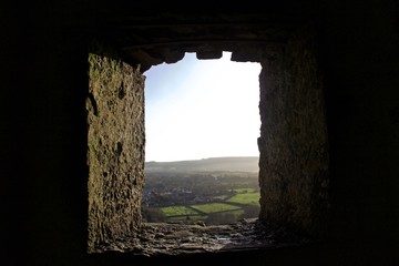 View From Stone Castle Window of Small English Country Town at Sunset