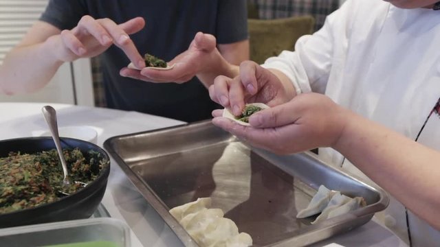 Technology of preparing chinesse dumplings with spinach by handmade. master class how to shape a dough with stuffing inside to make dumplings