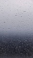 Rain drops at the window glass with blurred sky and forrest in the background with copy space for instagram stories size