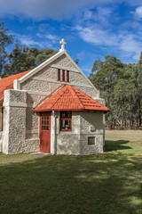 Fototapeta na wymiar Country stone church in rural landscape setting
