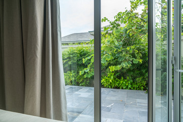 Open window in tropical villa. Summer garden, view outdoor