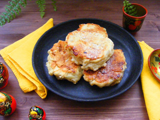 Traditional russian cuisine : pancakes  with oak flakes on cast iron and nesting dolls matreshka on...