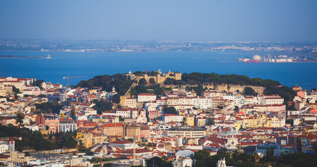 Beautiful super wide-angle aerial view of Lisbon, Portugal with harbor, skyline, scenery beyond the city and 25 de Abril Bridge, over the Tagus river, shot from belvedere observation deck