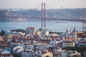 Obraz premium Beautiful super wide-angle aerial view of Lisbon, Portugal with harbor, skyline, scenery beyond the city and 25 de Abril Bridge, over the Tagus river, shot from belvedere observation deck