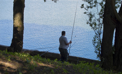 man fishing on the lake
