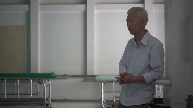 Asian senior elderly man worry about health medication fee at hospital