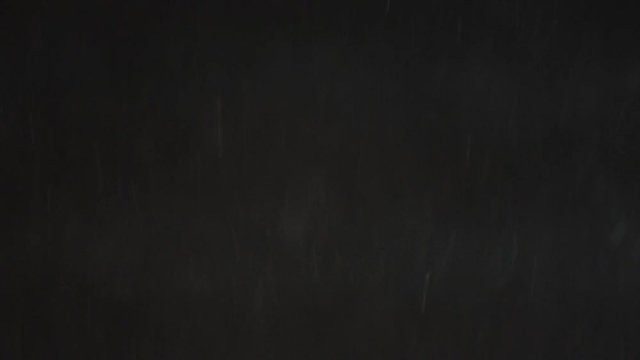 Real snow falling on black background