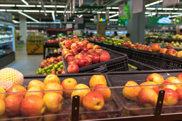 Fresh healthy fruits on shelves in supermarket