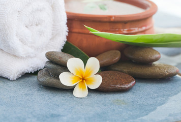 Obraz na płótnie Canvas spa tropical set with stones for relax massage treatment