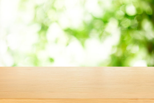 wooden plank table top with blur park green nature background bokeh light , for display or montage of product,Spring and Summer concept.