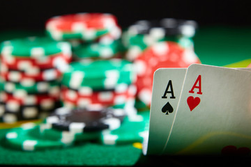 A pair of aces and chips on poker table. Winning hand.