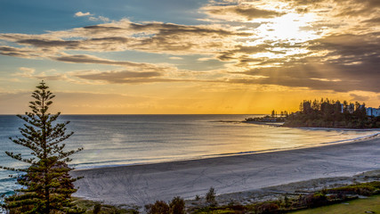 High view of cloudy sunrise over ocean and beach
